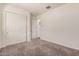 This bedroom features neutral carpeting and double door closet at 21255 W Ashland Ave, Buckeye, AZ 85396