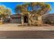 Charming home exterior featuring stone accents, desert landscaping and covered entryway at 21255 W Ashland Ave, Buckeye, AZ 85396