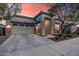 Charming home exterior featuring stone accents, desert landscaping and covered entryway at 21255 W Ashland Ave, Buckeye, AZ 85396