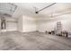 Two car garage featuring overhead storage and a white door leading outside at 21255 W Ashland Ave, Buckeye, AZ 85396