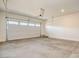 Spacious two-car garage showcasing a clean concrete floor, white walls, and an automatic garage door opener at 21255 W Ashland Ave, Buckeye, AZ 85396