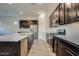 Modern kitchen featuring stainless steel appliances, a large island, and dark cabinets at 21255 W Ashland Ave, Buckeye, AZ 85396
