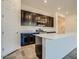 Modern kitchen features dark cabinets, stainless steel appliances, and a spacious white island at 21255 W Ashland Ave, Buckeye, AZ 85396