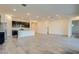 Expansive living room featuring a modern kitchen, plenty of space, and beautiful natural light at 21255 W Ashland Ave, Buckeye, AZ 85396