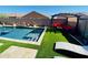 An inviting backyard pool area with a pergola, lounge chairs, and a comfortable seating area with a fire pit at 21255 W Ashland Ave, Buckeye, AZ 85396