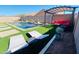 A backyard pool featuring a pergola, comfortable seating, and a pristine artificial grass surround at 21255 W Ashland Ave, Buckeye, AZ 85396