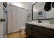 Well-lit bathroom with a modern sink, a toilet, and a stylish shower curtain at 2315 E Pecan Rd, Phoenix, AZ 85040