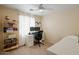 Comfortable bedroom with a ceiling fan, a desk setup, and a cozy bed for relaxation at 2315 E Pecan Rd, Phoenix, AZ 85040