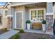 Inviting front porch with stone pillars, bench, and decorative plants at 2315 E Pecan Rd, Phoenix, AZ 85040