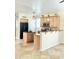 Eat-in kitchen with stainless steel microwave, wood cabinets, tile backsplash and black refrigerator at 2315 E Pecan Rd, Phoenix, AZ 85040