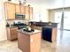 Kitchen with stainless steel appliances, tile flooring, wood cabinets, and a kitchen island at 2315 E Pecan Rd, Phoenix, AZ 85040