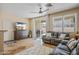 Comfortable living room with a leather sofa, sliding glass doors to patio, and a ceiling fan at 2315 E Pecan Rd, Phoenix, AZ 85040