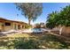 Picture of spacious backyard features a pool, shaded seating area, and mature trees at 2407 W Paradise Ln, Phoenix, AZ 85023