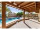 Beautiful backyard with pool, covered patio, string lights and mature landscaping at 2407 W Paradise Ln, Phoenix, AZ 85023