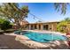 Lovely backyard featuring a refreshing pool, covered patio, and mature trees at 2407 W Paradise Ln, Phoenix, AZ 85023