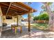 Inviting covered patio featuring brick pavers, a dining table and backyard views at 2407 W Paradise Ln, Phoenix, AZ 85023