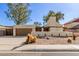 Inviting single-story home with a desert landscape and a two-car garage at 2407 W Paradise Ln, Phoenix, AZ 85023
