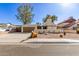 Inviting single-story home with a desert landscape and a two-car garage at 2407 W Paradise Ln, Phoenix, AZ 85023