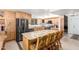 A kitchen features light-colored wooden cabinets, stainless steel appliances, and a large island with seating for four at 2407 W Paradise Ln, Phoenix, AZ 85023