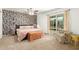 A main bedroom boasts a unique accent wall, a ceiling fan, and a sliding glass door to the backyard pool at 2407 W Paradise Ln, Phoenix, AZ 85023