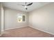 Bedroom featuring neutral toned walls, carpet, a window with shutters and modern ceiling fan at 26635 W Covey Ln, Buckeye, AZ 85396