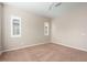 Empty bedroom featuring shuttered windows, neutral walls, and carpeted floor at 26635 W Covey Ln, Buckeye, AZ 85396