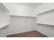 Walk-in closet featuring ample shelving space and neutral carpet at 26635 W Covey Ln, Buckeye, AZ 85396