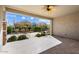 Inviting covered patio with ceiling fan, perfect for outdoor relaxation and overlooking manicured landscaping at 26635 W Covey Ln, Buckeye, AZ 85396