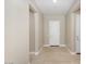 Bright entryway with neutral walls, tile flooring, and a view of the front door and adjacent rooms at 26635 W Covey Ln, Buckeye, AZ 85396