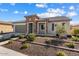 Inviting exterior view showcasing the home's stone accents, neutral color palette, and manicured front yard at 26635 W Covey Ln, Buckeye, AZ 85396