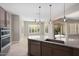 Beautiful kitchen island with stainless steel appliances and granite counters at 26635 W Covey Ln, Buckeye, AZ 85396