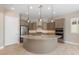 Modern kitchen features a large island with granite countertops and stainless steel appliances at 26635 W Covey Ln, Buckeye, AZ 85396