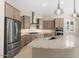 Modern kitchen features stainless steel appliances, granite counters, and stylish pendant lighting at 26635 W Covey Ln, Buckeye, AZ 85396