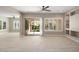 Spacious living area with tile floors, large windows, and a view of the dining area and backyard at 26635 W Covey Ln, Buckeye, AZ 85396