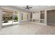 Bright and airy living area featuring tile flooring, recessed lighting, and sliding glass doors to the patio at 26635 W Covey Ln, Buckeye, AZ 85396