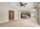 Open floorplan with tile flooring connecting the living area, dining space, and modern kitchen at 26635 W Covey Ln, Buckeye, AZ 85396