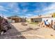 Backyard featuring a fire pit area, gravel landscaping, and outdoor seating at 2925 W Highland Ave, Phoenix, AZ 85017