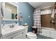 Bathroom featuring a white vanity, toilet, and tub with shower at 2925 W Highland Ave, Phoenix, AZ 85017