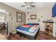 This is a cozy bedroom with a ceiling fan and comfortable sleeping arrangements at 2925 W Highland Ave, Phoenix, AZ 85017