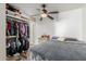 This bedroom shows the closet with shelves and the bed with gray blankets and a ceiling fan at 2925 W Highland Ave, Phoenix, AZ 85017