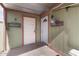 A sheltered entryway featuring two white doors and charming decorative elements at 2925 W Highland Ave, Phoenix, AZ 85017