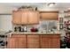 Practical kitchen with wooden cabinets, granite countertops, and open shelving at 2925 W Highland Ave, Phoenix, AZ 85017