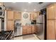 Functional kitchen with stainless steel appliances, ample cabinet space, and tiled floors at 2925 W Highland Ave, Phoenix, AZ 85017