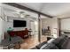 A cozy living room with TV, wooden beam, tile flooring, and comfortable seating at 2925 W Highland Ave, Phoenix, AZ 85017