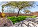 Well-maintained backyard with a putting green, desert landscaping, and a paver walkway at 2951 W Plum Hollow Dr, Anthem, AZ 85086