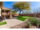 Beautiful backyard featuring a putting green, desert landscaping, and a covered patio area perfect for entertaining at 2951 W Plum Hollow Dr, Anthem, AZ 85086