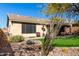 Spacious backyard featuring a well-manicured lawn, desert landscaping, and a covered patio area at 2951 W Plum Hollow Dr, Anthem, AZ 85086