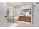 Bright bathroom with a glass-enclosed shower, a soaking tub, and double vanities at 2951 W Plum Hollow Dr, Anthem, AZ 85086