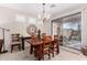 Elegant dining room with a chandelier, a wood table, and sliding glass doors at 2951 W Plum Hollow Dr, Anthem, AZ 85086
