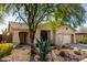 Charming home with desert landscaping, mature trees, and a welcoming entrance at 2951 W Plum Hollow Dr, Anthem, AZ 85086